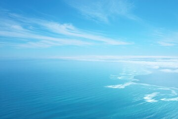 Obraz premium aerial view of vast serene ocean with gentle waves showcasing endless blue horizon and sky above