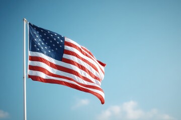 Obraz premium american flag waving gently against clear blue sky minimalistic composition with ample copy space below highlighting
