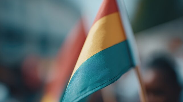 capture minimalistic celebration of juneteenth with flags or symbols in focus and people in background blurred creating