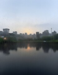 Fototapeta premium A Pane Between Warmth and the Distant Rain