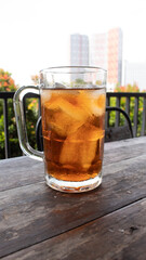 Sweet Iced Tea in Clear Glass on Wooden Table – Refreshing Beverage Photo