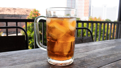 Sweet Iced Tea in Clear Glass on Wooden Table – Refreshing Beverage Photo