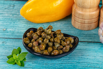 Pickled canned capers in the bowl