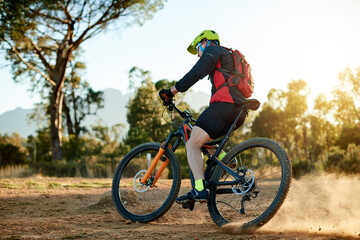 Obraz premium Mountain bike, training and man with fitness, travel and environment with competition. Person, adrenaline or cyclist with practice, hobby or countryside with adventure, challenge or nature with hobby