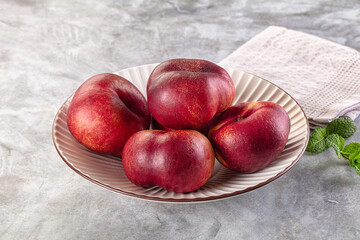 Ripe sweet juicy flat nectarines heap