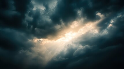 Obraz premium A powerful image of the sun breaking through dark storm clouds after heavy rain.