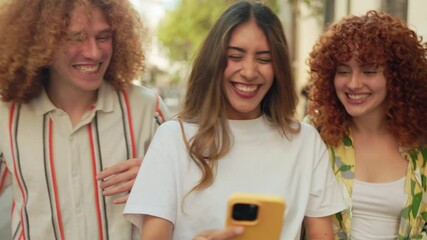 Young friends sharing laughter and mobile moments on city stroll