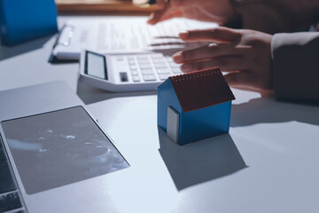 Female Real Estate Broker presenting and advised to .model home and building project detail in the...