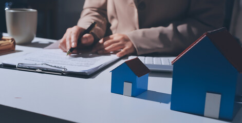 Female Real Estate Broker presenting and advised to .model home and building project detail in the...