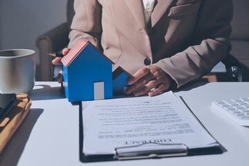 Female Real Estate Broker presenting and advised to .model home and building project detail in the...