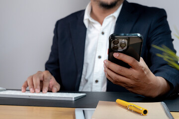 Cropped image of a businessman holding a smartphone