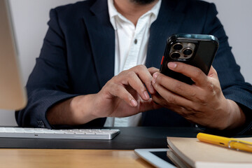 Cropped image of a businessman holding a smartphone