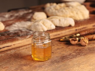 In a sunlit rustic kitchen, a baker gently drizzles raw honey over freshly baked bread, celebrating the natural sweetness of artisanal ingredients and farm-fresh goodness