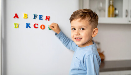 Happy Child Playing with Colorful Letters on Kitchen Refrigerator