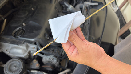 Mechanic man hand checking engine oil refill car maintenance close up engine transport industry....