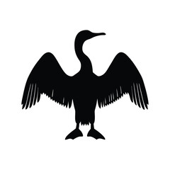Silhouette of a cormorant bird with wings spread, drying in the sun
