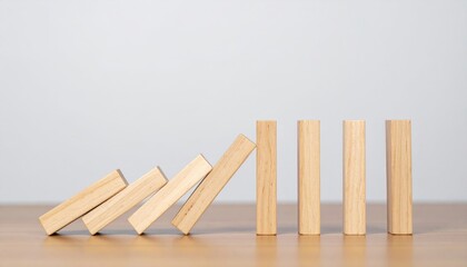 Domino effect of wooden blocks in risk management business environment conceptual visualization