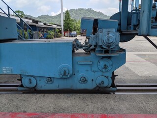 Industrial Machinery Close-up: A Detailed View of a Blue Gantry Crane's Trolley Mechanism
