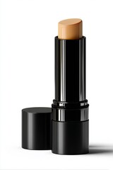 Obraz premium A sleek makeup stick, cap off, reveals a creamy beige foundation against a white background.