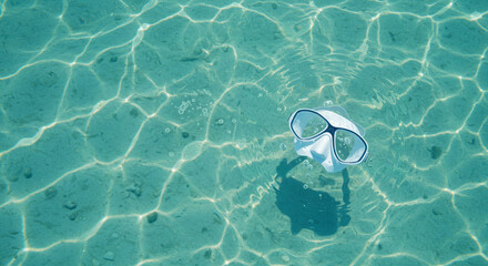 Snorkeling mask floating in clear turquoise water, for summer travel blogs