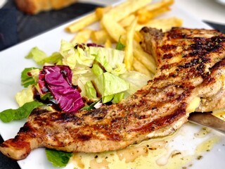Grilled Pork Chop with Salad and French Fries