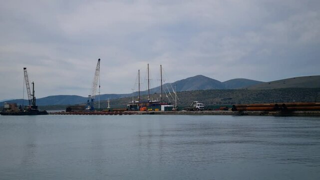 Port of Itea with Industrial Structures and Docked Sailing Ship