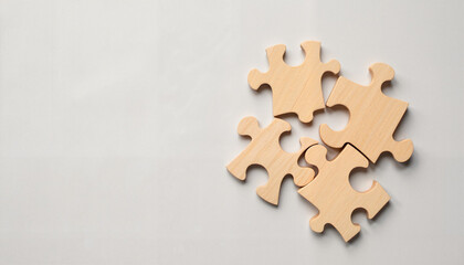 Fototapeta premium Wooden puzzle pieces on light gray background