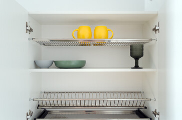 clean kitchen utensils in the cupboard