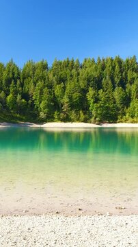 Nature panorama with turquoise mountain lake Urisee and peaceful alpine environment near Reutte in the Austrian Tyrol