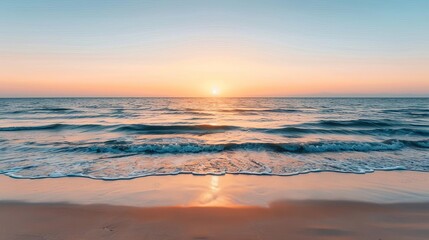 Fototapeta premium Serene ocean view du sunrise with gentle waves hitting sandy beach and colorful sky creating peaceful calming atmosphere in natural coastal scene