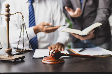 Lawyer discussing legal case and working with contract. Two lawyers deeply discussing a complex...