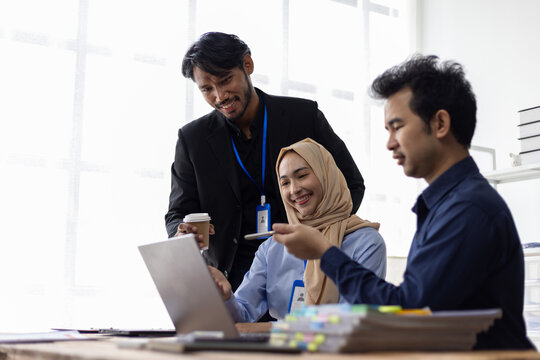 Business meeting with diverse team analyzing financial data. Businesspeople having a discussion with coworker in the office. They are working on a project together.