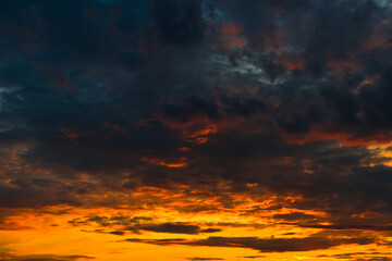 Orange and black clouds in the sunset sky