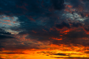 Orange, red and black clouds in the sunset sky