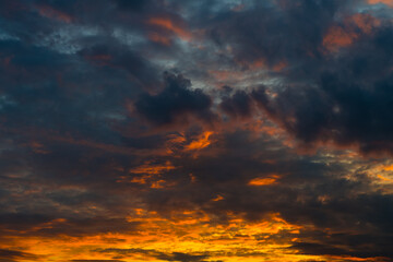 Orange and black clouds in the sunset sky