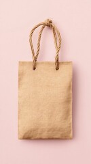 Small Beige Burlap Shopping Bag with Rope Handles on Pink Background