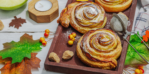 Apple roses pie with sugar powder. Traditional autumn baking, fall decor, flat lay