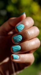 Bright turquoise nails with elegant white designs under the sun in a lush garden setting