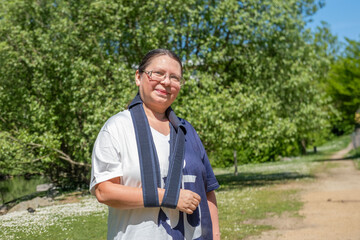 Woman with shoulder bandage, Orthopedic arm sling, post-surgery support, medical care, healthcare,...