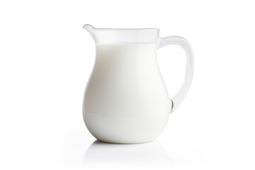 Milk glass jug with a smooth curved handle and a wide pouring spout filled with fresh white milk placed on a clean surface