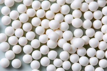Smooth round white plastic pellets used for industrial and polymer production