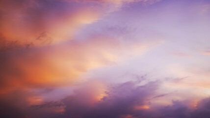 Obraz premium Blurred sunset sky background with warm orange and purple tones, peaceful and dreamy mood