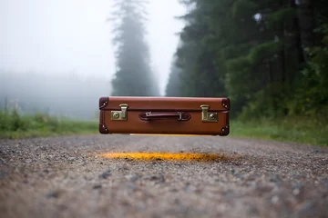 Fototapete Floating suitcase with glowing light © Creativeraf