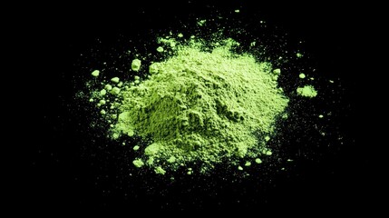 Top view of matcha powder in smooth pile, glowing green hue against black backdrop