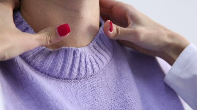medicine, healthcare and medical exam concept - doctor or nurse checking patient's tonsils at hospital. Endocrinologist examining throat of young woman in clinic
