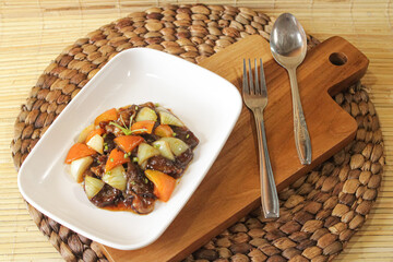 A plate of stir-fried beef. stir-fried beef restaurant menu