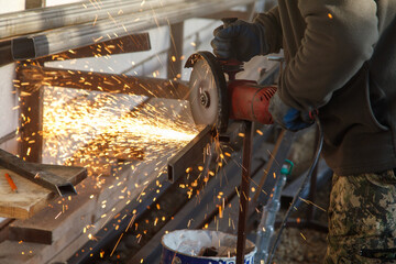 A man is cutting metal with a saw