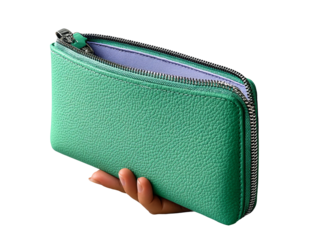An elegant green wallet held in a delicate hand. The wallet features a zipper and is partially open, revealing its interior