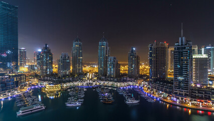 Dubai Marina all night timelapse, Glittering lights and tallest skyscrapers during a clear evening
