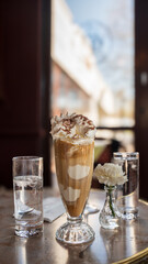 Chilled coffee and ice cream topped with whipped cream or Schlag. A delightful fusion drink for...